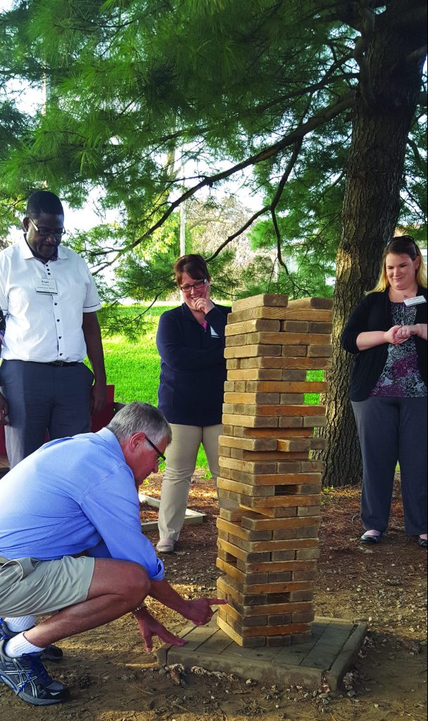 Country Meadows employees playing a giant game of Jenga